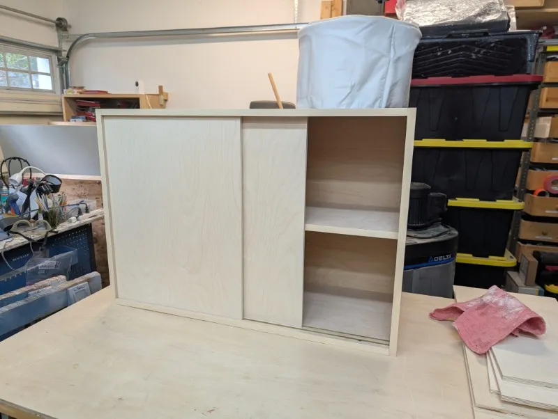 A storage cabinet with sliding doors