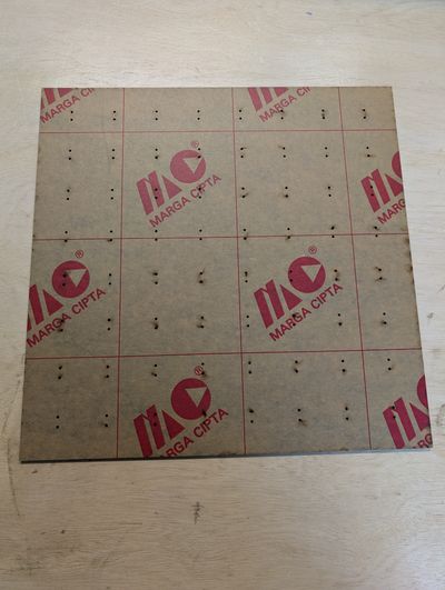 A piece of acrylic with mounting holes for 64 Breadboard-friendly NeoPixel devices