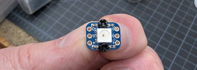Breadboard-friendly NeoPixel face up with bolts coming out the top