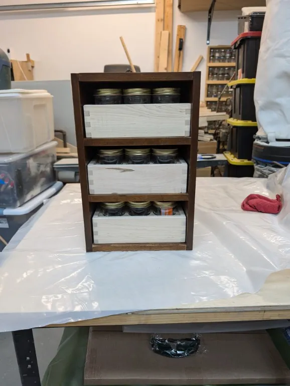 A stack of jar drawers in a case